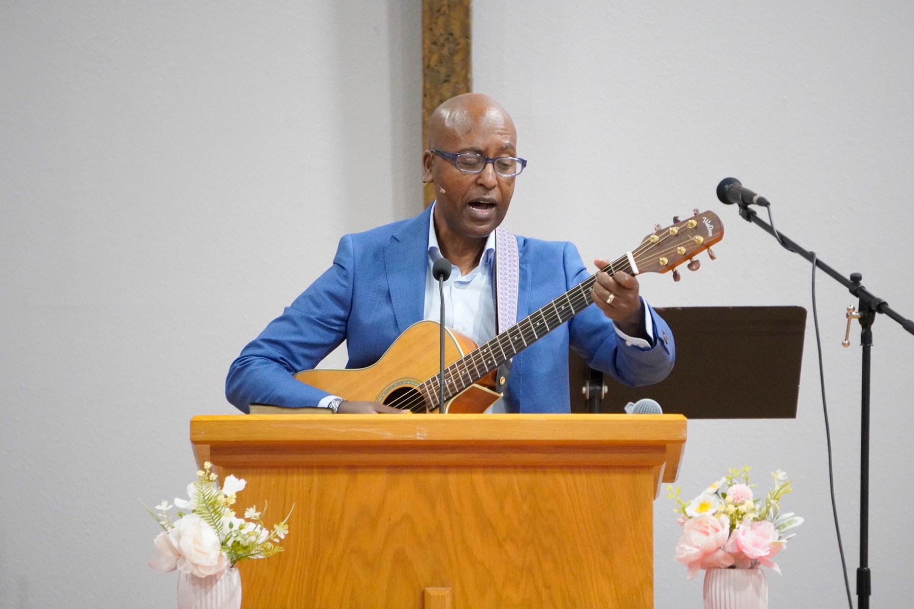 Worship leader singing with guitar