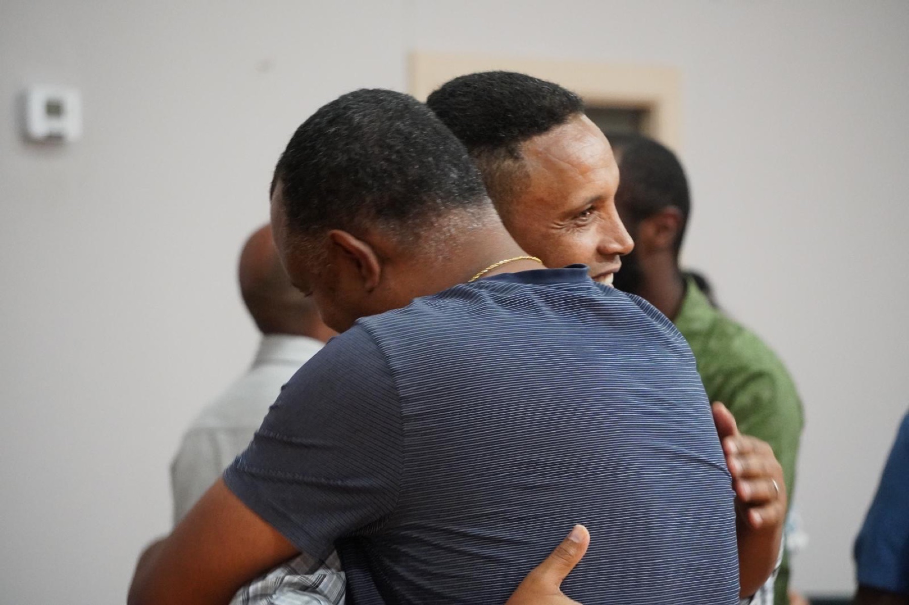 Church family greeting with a hug